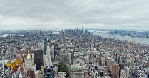 Wide shot of lower Manhattan with financial district, World Trade Center, Flatiron building, East River and Hudson River framing New York City, filmed from vantage point.