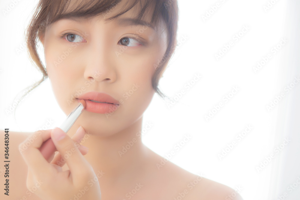 Beautiful portrait young asian woman looking mirror applying makeup lipstick at room, beauty lips asia girl makeup and cosmetic fashion on mouth at home, lifestyle and health care concept. Beautiful portrait young asian woman looking mirror applying makeup lipstick at room, beauty lips asia girl makeup and cosmetic fashion on mouth at home, lifestyle and health care concept.