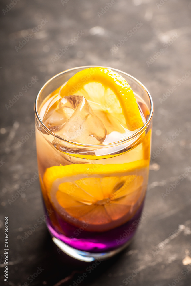Gin based colorful cocktail with lemon and lavender liqueur on the rustic background. Selective focus. Shallow depth of field. Gin based colorful cocktail with lemon and lavender liqueur on the rustic background. Selective focus. Shallow depth of field.