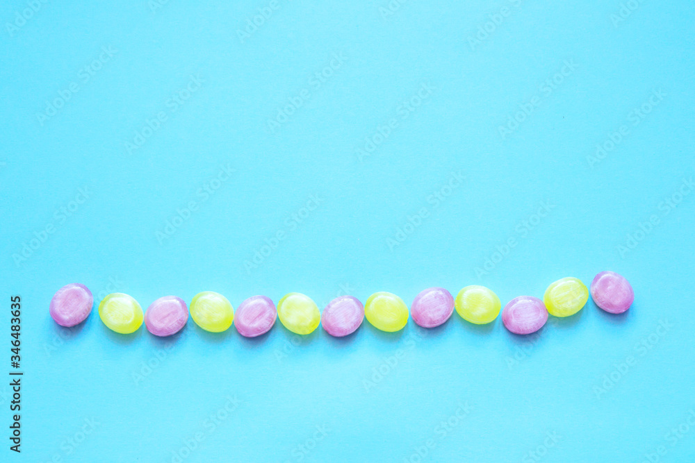 Obraz premium Multicolored candys on a colored background
