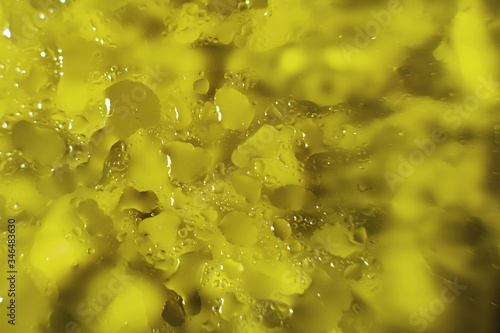 water drops on a yellow background. Abstract yellow background. Water drops on glass.