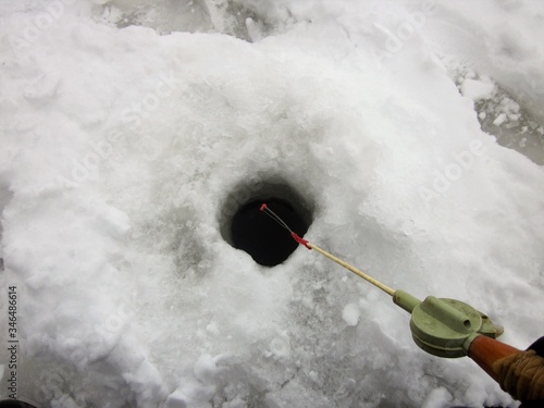  Winter fishing rod over the hole.