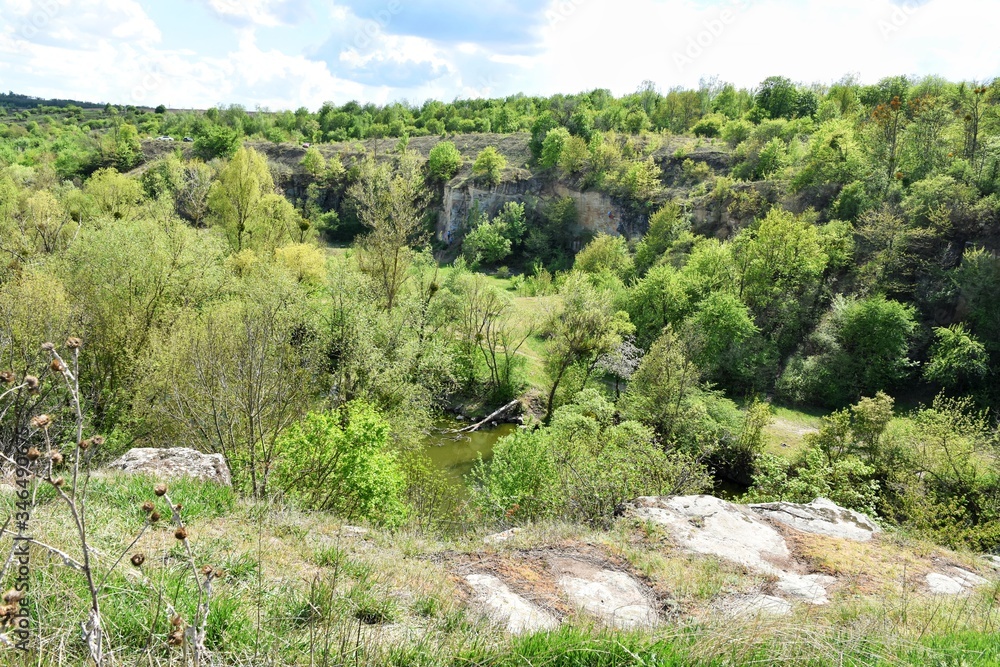 Beautiful peaceful landscape with green forest and mountain river near of the Buky canyon, Cherkasy region, Ukraine. Ukrainian landmarks. Domestic tourism. Buki canyon