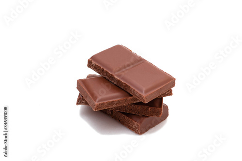 Pieces of chocolate on a white background, isolate. Broken chocolate bar