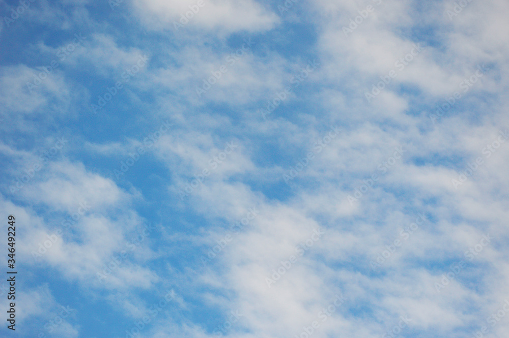 light white clouds in the blue sky. the sky is covered with white fluffy clouds light white clouds in the blue sky. the sky is covered with white fluffy clouds