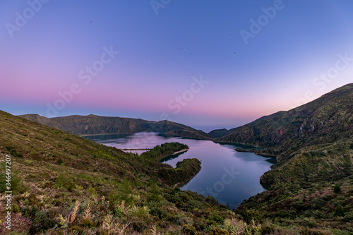Beautiful panoramic view of Lagoa do Fogo, Lake of Fire, in Sao Miguel Island, Azores, Portugal. Night Fall with Purple Sky and Birds