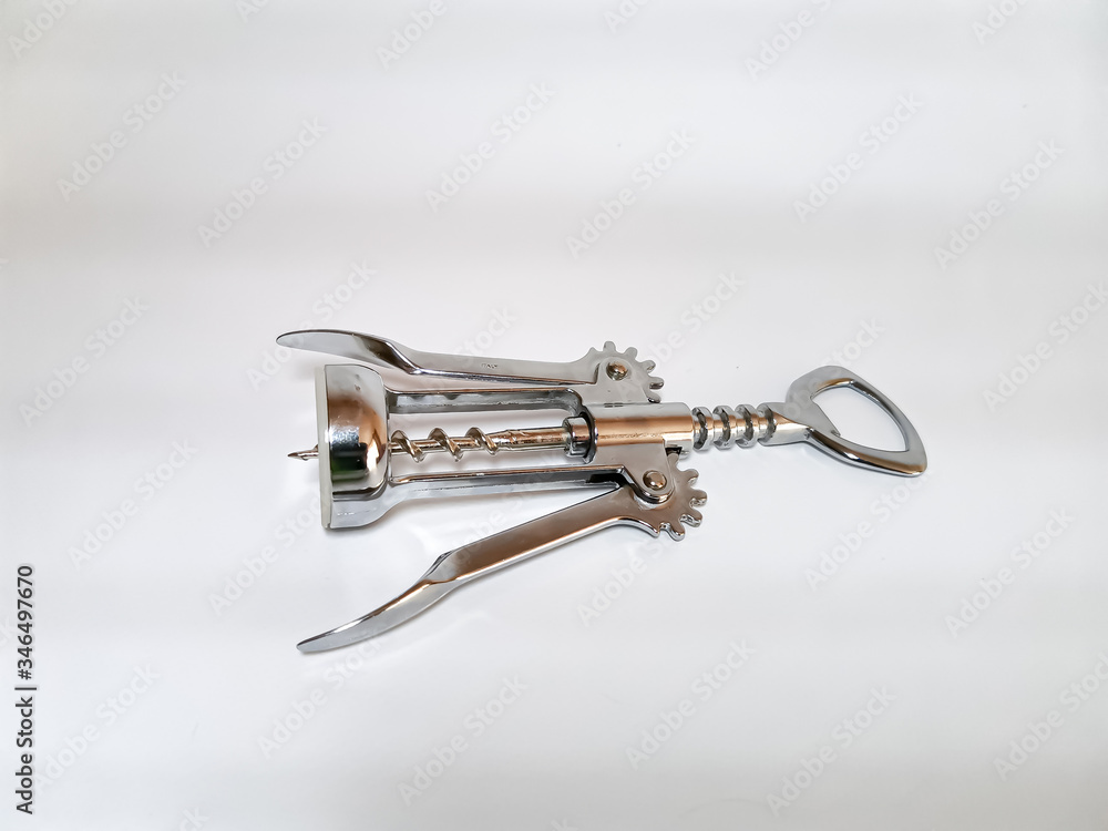 Kitchen utensils. Close-up of a metal corkscrew for wine on a white background. Kitchen utensils. Close-up of a metal corkscrew for wine on a white background.