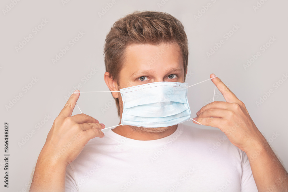 Portrait of a man adult young in a medical mask on an isolated background Portrait of a man adult young in a medical mask on an isolated background