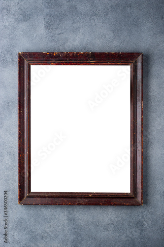 Old wooden picture frame on a gray background.