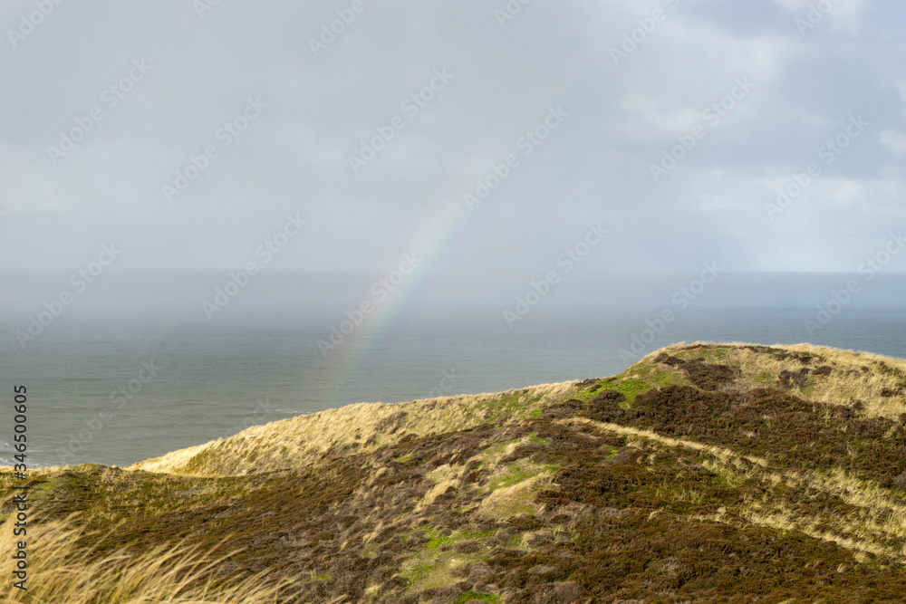 View of the North Sea with rainbow and dunes View of the North Sea with rainbow and dunes