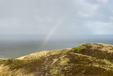View of the North Sea with rainbow and dunes