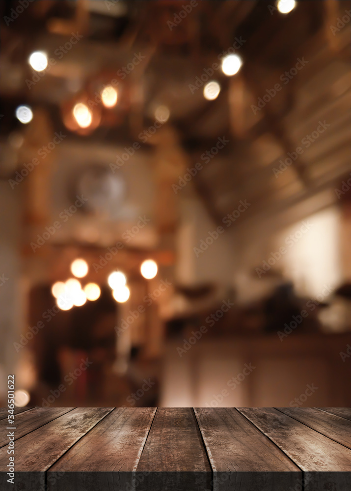 Empty wood table on blur restaurant background.