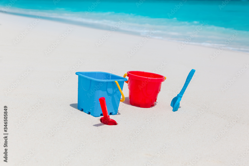 kids toys on tropical sand beach, family vacation