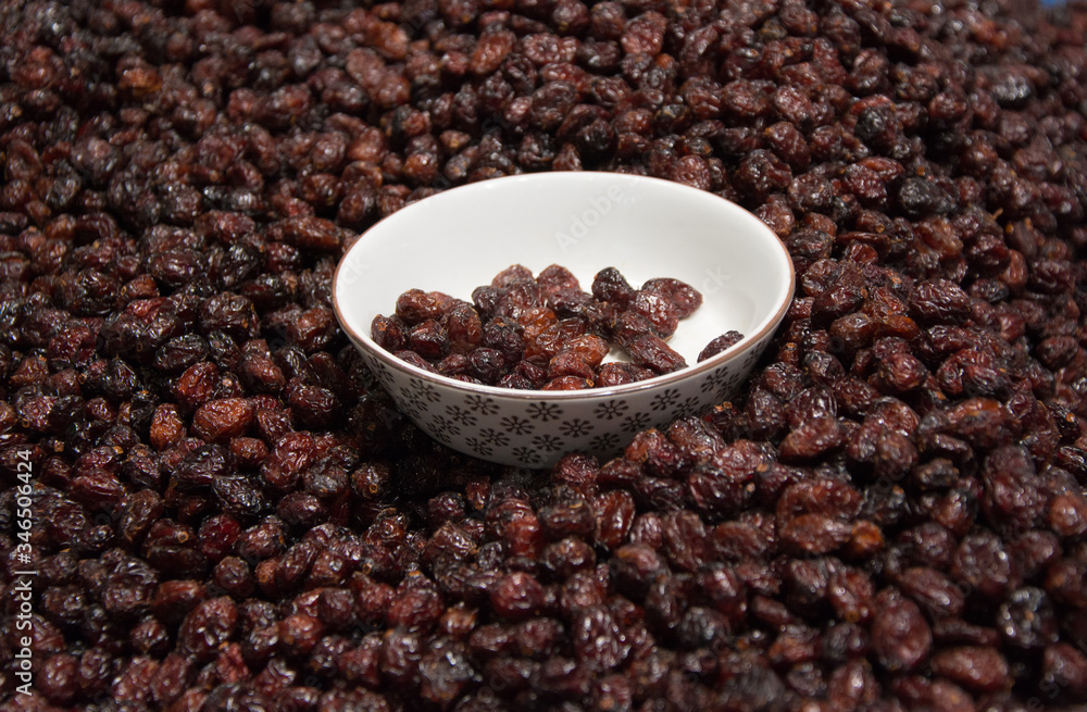Bowl of raisins on raisins background Bowl of raisins on raisins background