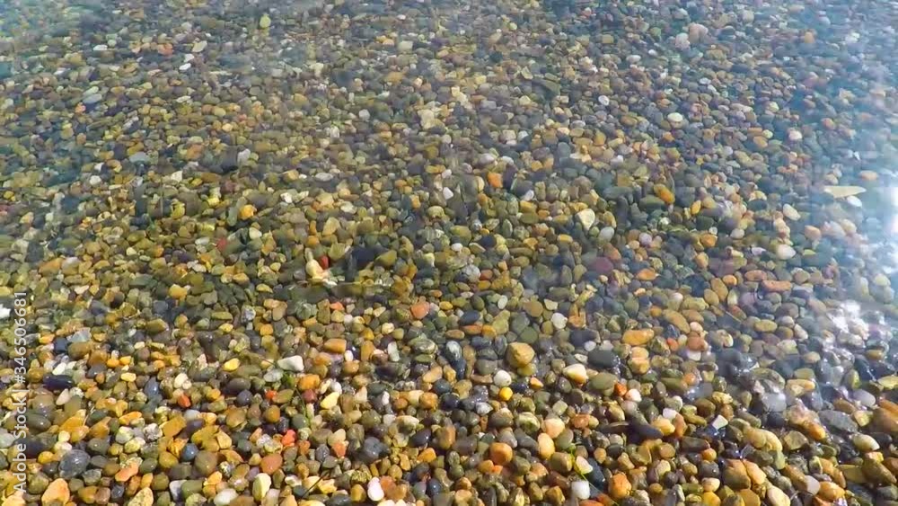 Pebbles and surf. Seascape. Clear water near the shore. Summer. Pebbles and surf. Seascape. Clear water near the shore. Summer.