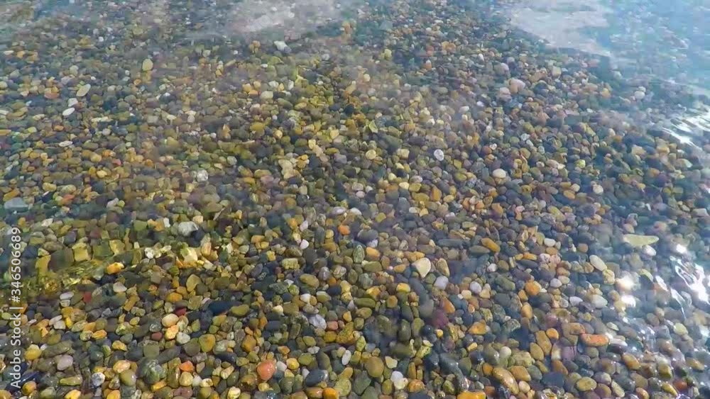Pebbles and surf. Seascape. Clear water near the shore. Summer. Pebbles and surf. Seascape. Clear water near the shore. Summer.