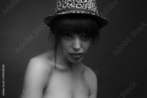 black and white brunette in a hat with off the shoulder neckline.