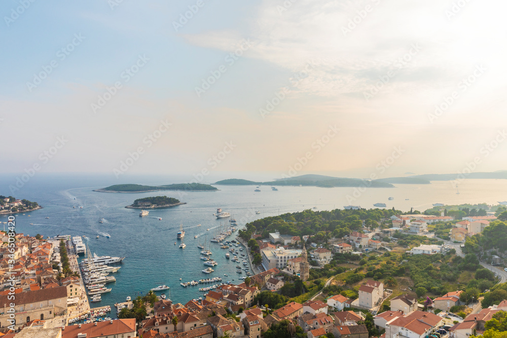 Hvar town on Hvar island, view from the fortress on a sunny day in the summer. Clear Adriatic sea water, the south mediterranean coast of Croatia Europe. Beautiful landscape with greenery, idyllic