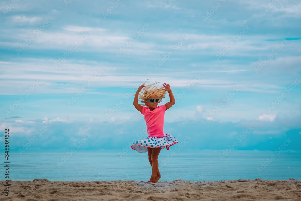 cute little girl dance, child play at summer beach cute little girl dance, child play at summer beach