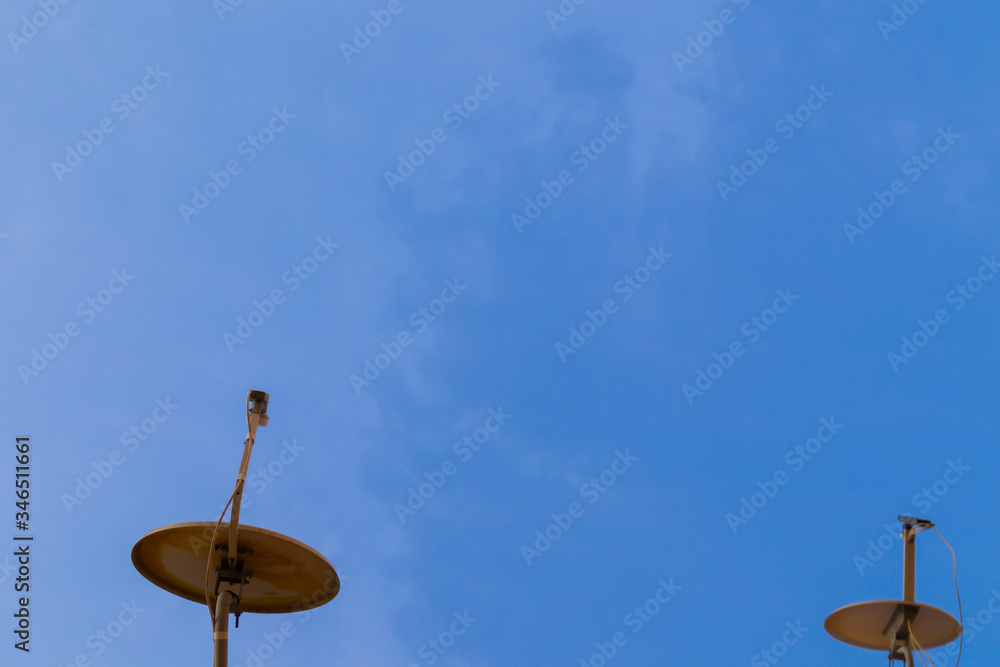 Two satellite antennas with space on blue sky. Background. Two satellite antennas with space on blue sky. Background.