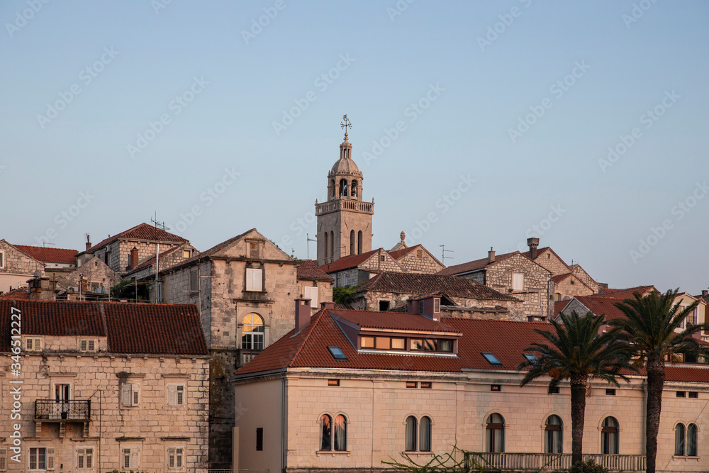 Korcula island with the cathedral, detail shot from the sea on a sunny day during sunset in summer. Beautiful old venetian architecture and palm trees creating an idyllic scenery. Holiday destination