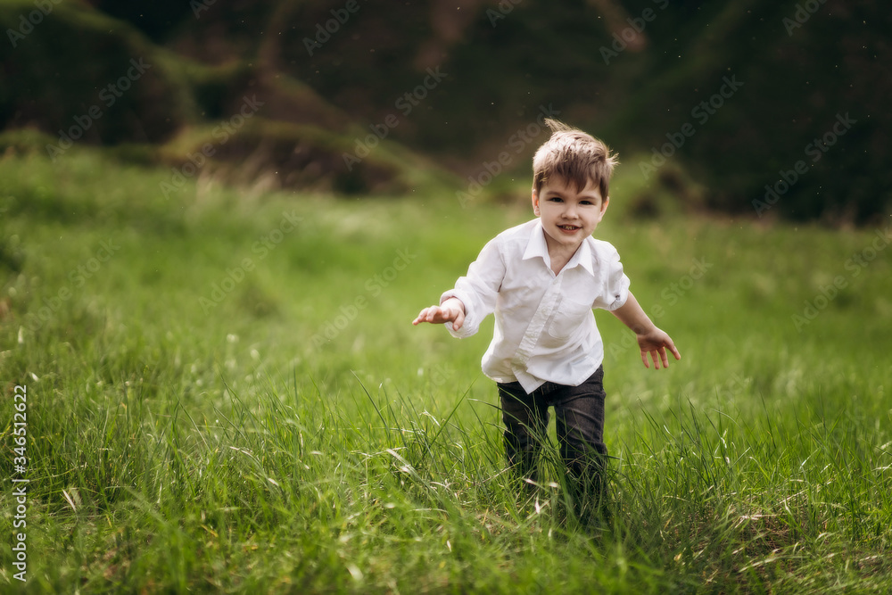 child with a smile on the green hills, fields child with a smile on the green hills, fields