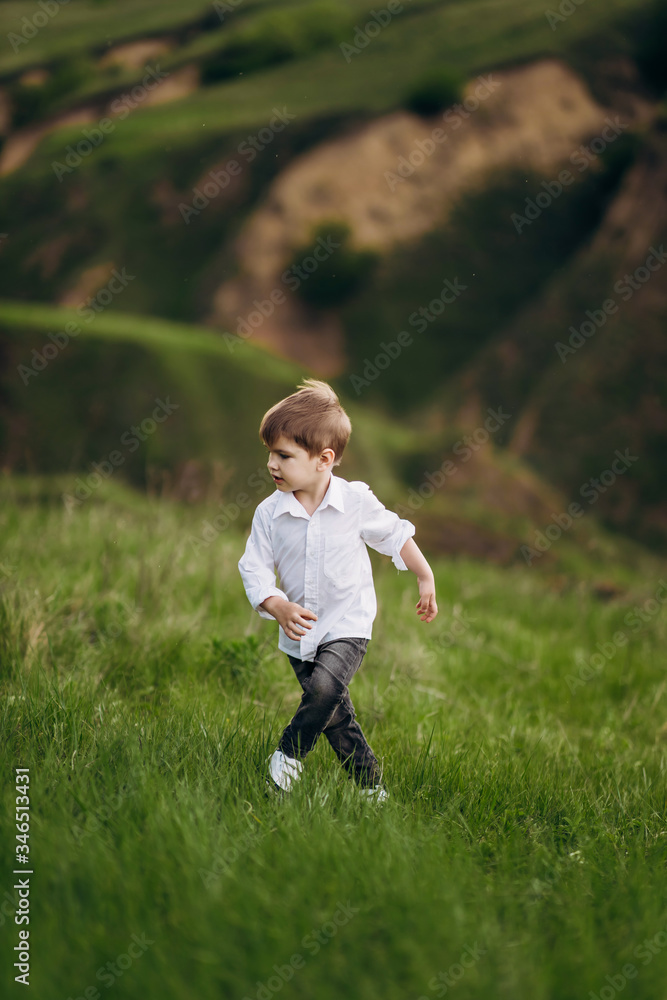child with a smile on the green hills, fields child with a smile on the green hills, fields