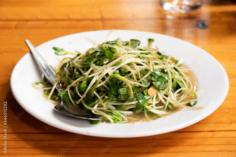 Fried sunflower sprout on white dish background Fried sunflower sprout on white dish background