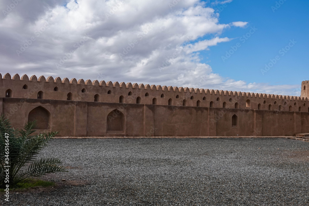 Clay Fort Walls with Mountains on Background. Detail of Typical Architecture in Oman. Building for Defence and Protection in Arab Middle East Countries