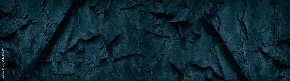 Dark blue green stone background. Grunge background. Banner with toned rock texture. The combination of teal color and rough mountain texture. Dark blue green stone background. Grunge background. Banner with toned rock texture. The combination of teal color and rough mountain texture.
