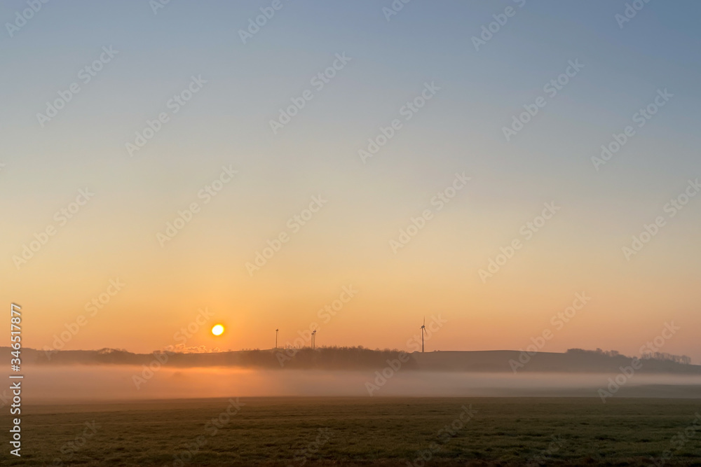Sunrise over a meadow with ground fog