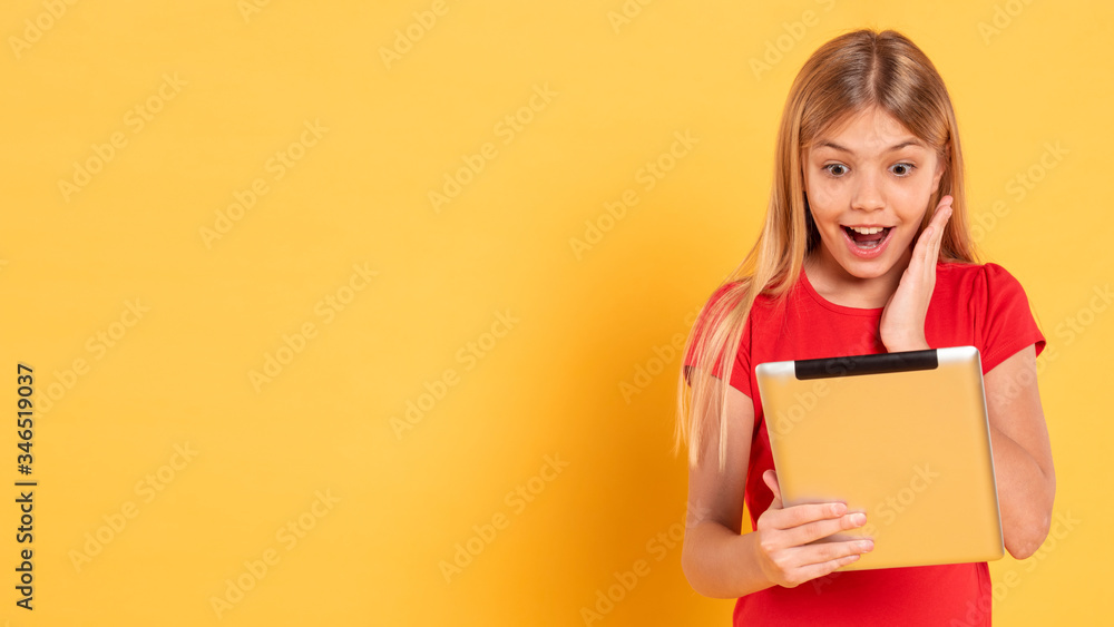 Copy-space girl playing on tablet Copy-space girl playing on tablet