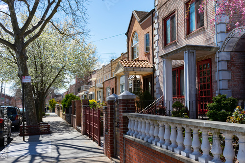 Canvas Print Row of Beautiful Homes along a Sidewalk during Spring in Astoria Queens New York