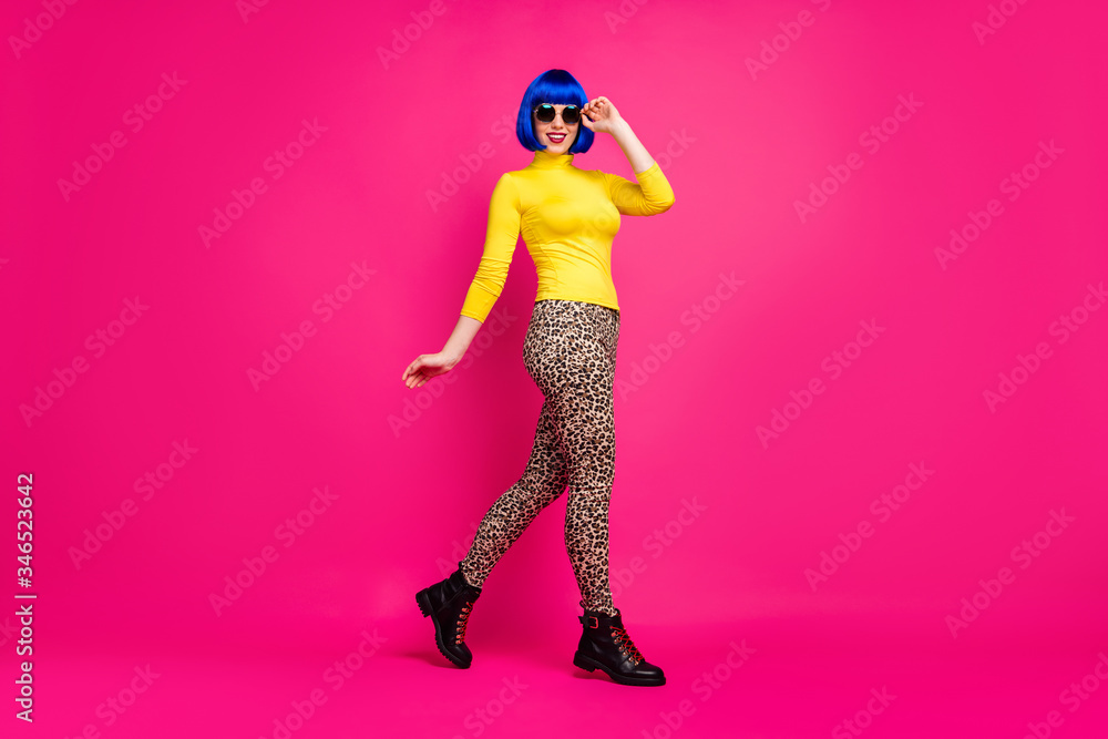 Full length profile photo of cheerful lady walk street trend traveler wear specs yellow turtleneck blue short wig boots leopard pants isolated bright pink color background