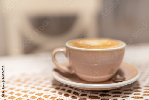Cup of cappuccino on table with soft blurred background