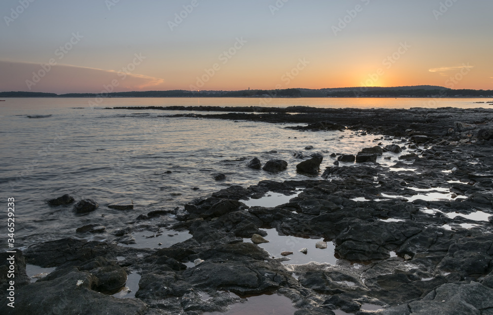 Sunset on the rocky beach of the Adriatic Sea, Medulin, Croatia Sunset on the rocky beach of the Adriatic Sea, Medulin, Croatia