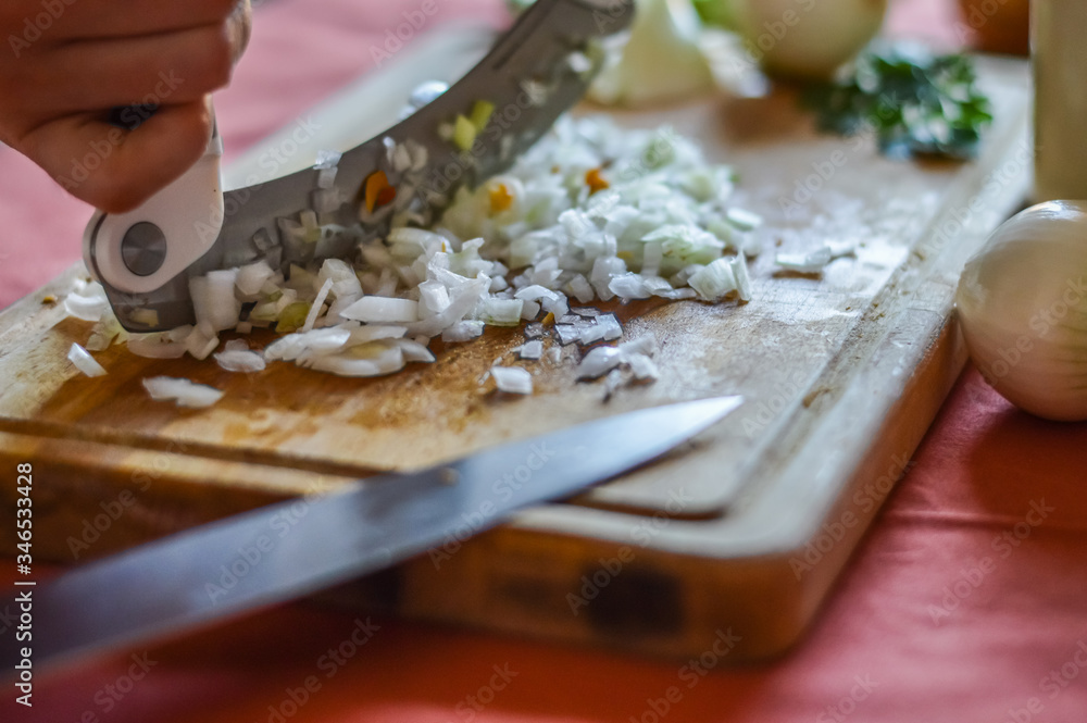 mincing onions very small while preparing food in the kitchen