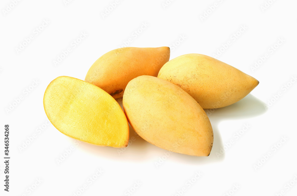 Fresh Ripe Thai Mango Cut in Half with Heap of Whole Fruit Isolated on White Background	
