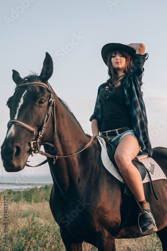beautiful stylish fashion woman near horse on ranch. Fashion girl hugging a horse.
