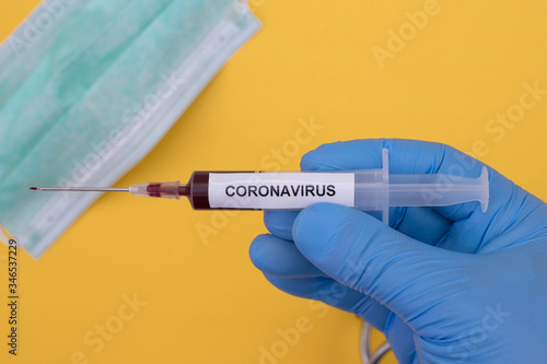 Coronavirus (COVID-19) testng concept, Hand holds a test tube containing a blood sample.. photo