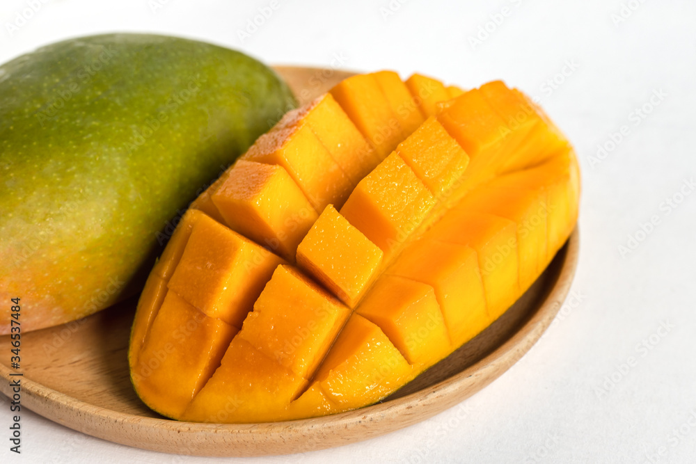 Mango in wooden plate on white background. Mango in wooden plate on white background.