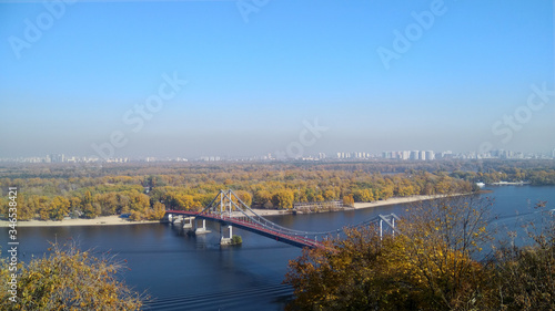 Kiev. Ukraine. Urban landscape of Old bridge of Lovers across the blue river Dnipro
