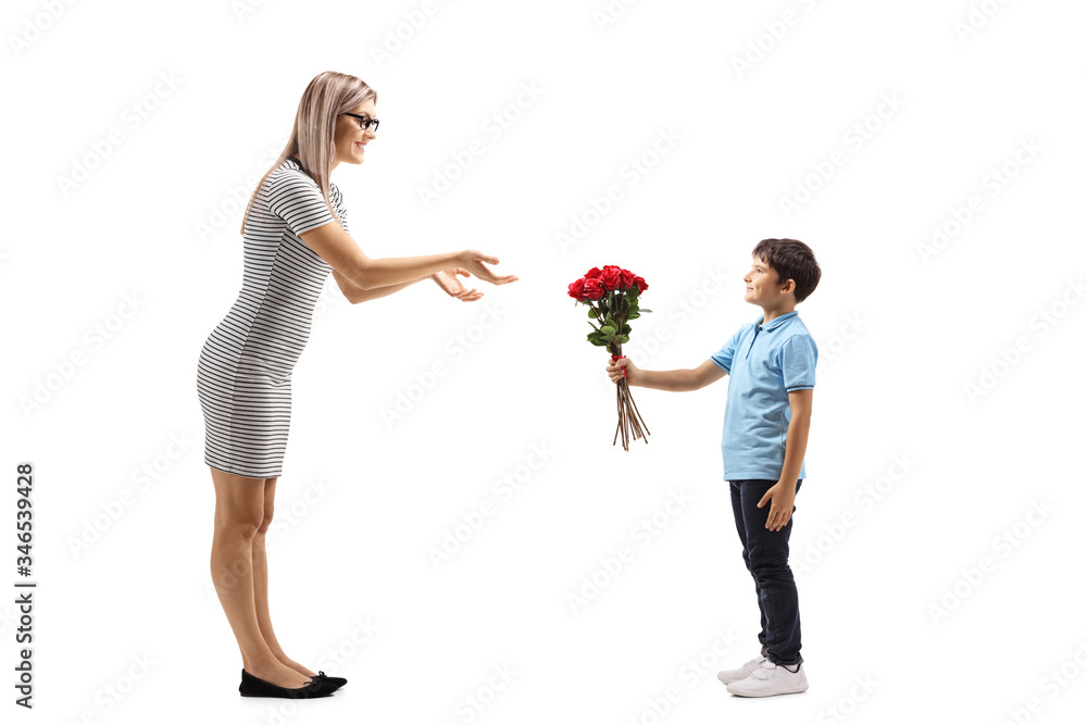 Boy giving a bunch of red roses to a young woman Boy giving a bunch of red roses to a young woman