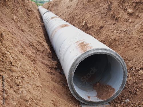 Wallpaper Mural Vertical concrete drain in the hole Drainage systems under construction at the construction site On the ground background. Selective focus Torontodigital.ca