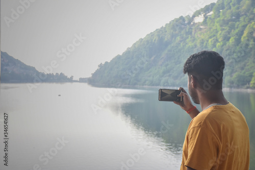 Canvas Print boy clicking a photo of mountain and lake, in nainital, Nainital Tourism