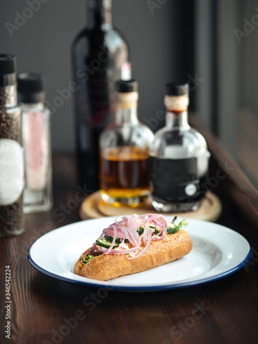 Appetizing hot dog with red onion and cucumber 