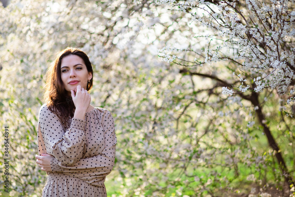 Beautiful happy young woman enjoying smell in a flowering spring garden Beautiful happy young woman enjoying smell in a flowering spring garden