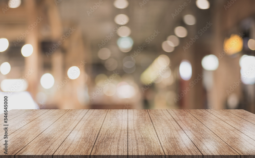 Wooden top table with bokeh light effect and blur restaurant on background, blur background. Wooden top table with bokeh light effect and blur restaurant on background, blur background.