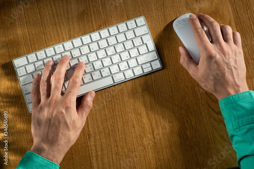 close-up of men's hands, keyboard and mouse