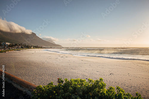 Evening golden light sunset in Camps Bay, Cape Town. Empty beach with no people.